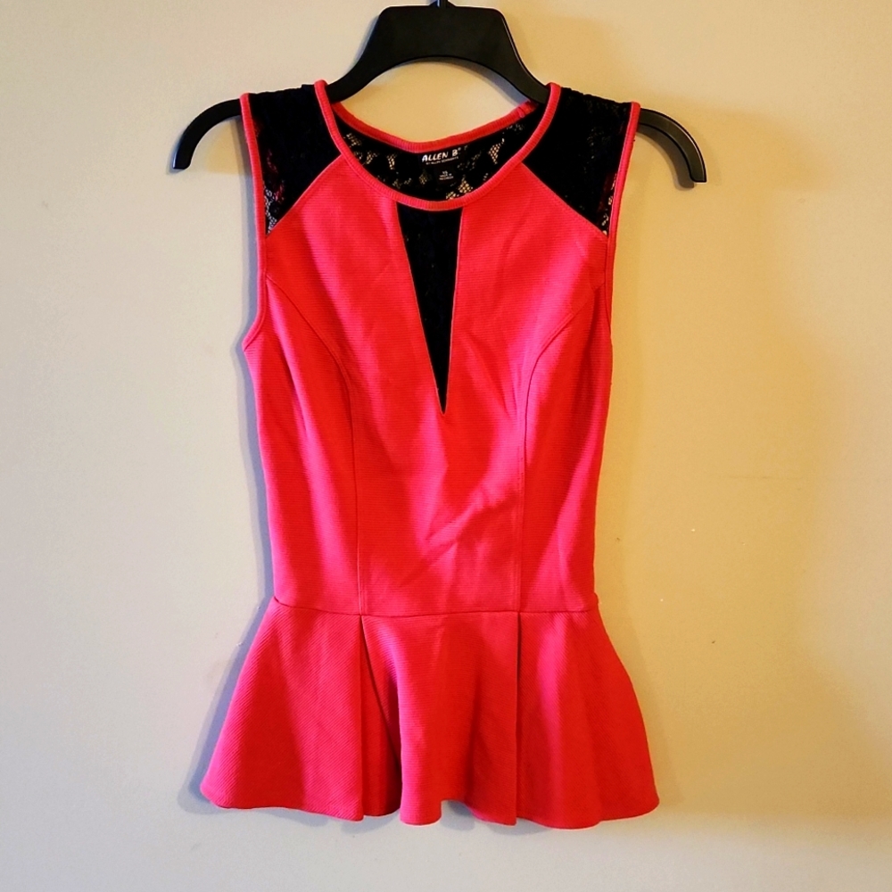 Coral colored peplum top with black lace front v, shoulder,& upper back design.